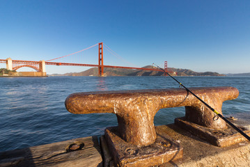 Fishing rod on an iron dock cleat.