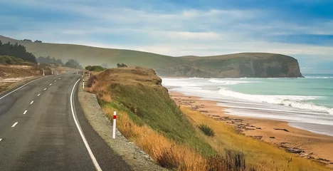 Fototapeten Empty road along New Zealand coast © Pav-Pro Photography 
