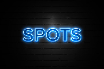 Spots neon Sign on brickwall