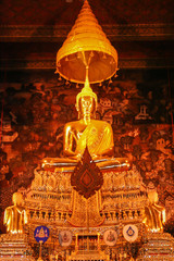 Statue of a golden Buddha inside a temple