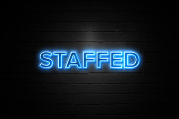Obraz premium Staffed neon Sign on brickwall