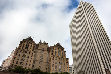 View from below of buildings modern and old styles.