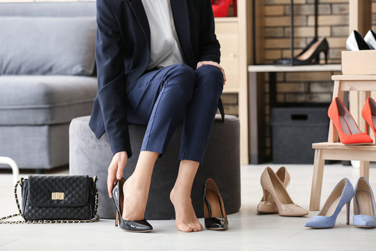 Young Woman Trying On Shoes In Shop