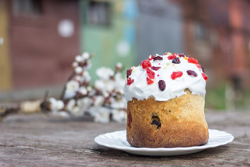 Beautiful Easter pastries on a white platter amid a blossoming bouquet of apricots