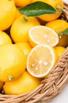 Basket of lemons including lemon slices.