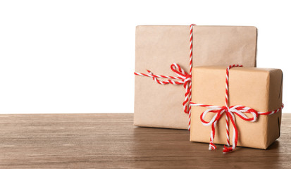 Parcel gift boxes on wooden table against white background