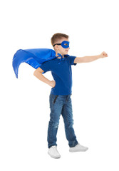 Cute boy in superhero costume on white background