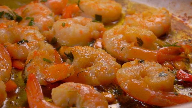 Cooking shrimp in a frying pan. Circular motion of the camera