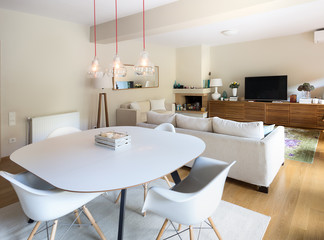 Dining - Living room with eiffel arm chairs and wooden cabinet.