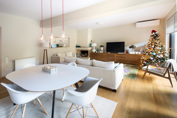 Dining - Living room with eiffel arm chairs and wooden cabinet.