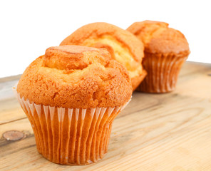 tasty muffin cake, isolated on wooden board