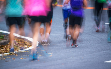People running in a city marathon on street