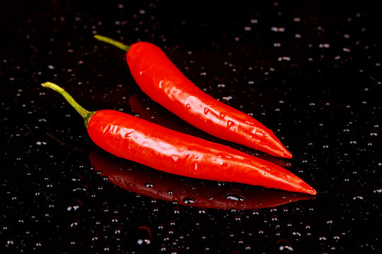 Red hot chili pepper on a dark background with space under the text