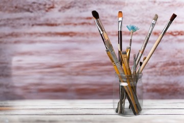 Brushes in a glass jar