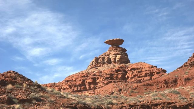zoom in shot of of the large flat rock known as mexican hat in utah, usa