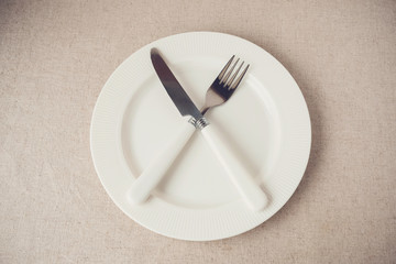 white plate with knife and fork, Intermittent fasting concept, ketogenic diet, weight loss