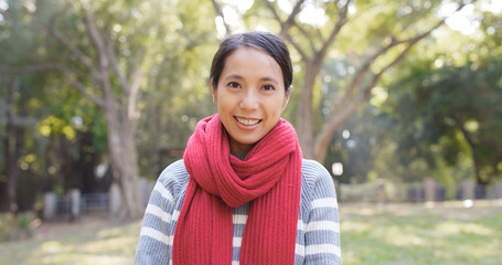 Happy woman in city park over sunlight flare