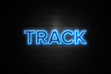 Track neon Sign on brickwall