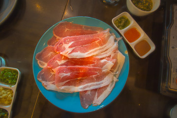 platter of Sliced pork on wood table.
