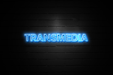 Transmedia neon Sign on brickwall