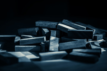 heap of wooden block on table with black background