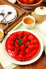 Freshly baked hot strawberry pie served on a white plate with tea       