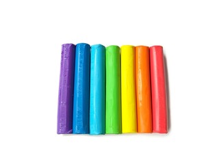 Colorful plasticine clay sticks put together on white background, multicolored line dough