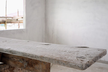 empty wood table at house building construction site