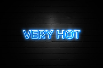 Very Hot neon Sign on brickwall