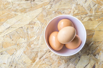 top view of eggs in bowl, egg on the table, copy space for text.