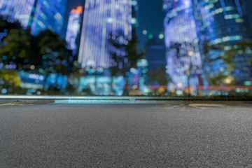 empty urban road with modern building at night