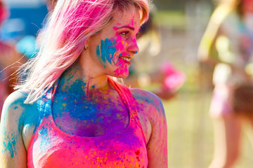 Painted girl dances at the Holi Festival