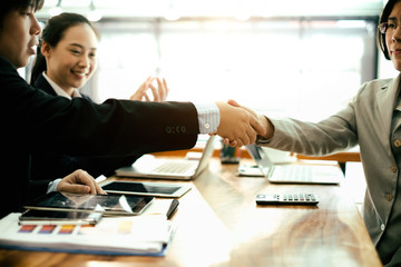 success business partners shaking hands after complete a deal in office, success deal and strategy concept