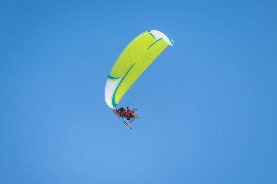 Powered parachute against the blue sky
