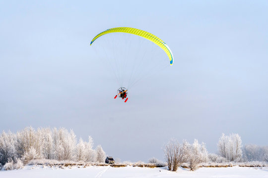 paraglider with two people in flight