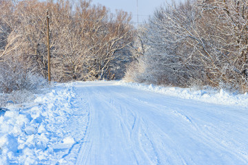 Obraz premium Snowy road after snowfall. Winter rural landscape