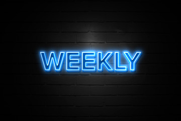 Weekly neon Sign on brickwall