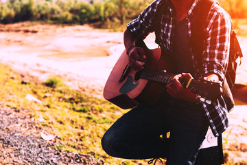 young man looking for freedom lifestyle ; man looking around the landmark at nature park.