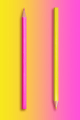  two pencils yellow and pink, gradient background from yellow to pink