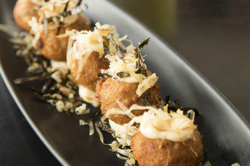 takoyaki on black plate - japanese food
