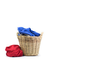 Clothes in a laundry wooden basket isolated on white