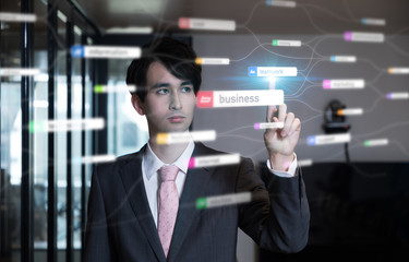 Business management concept. Young businessman pointing graphical user interface.