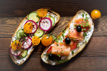 Healthy and tasty toast bread with tomato, radish, salmon fish and cheese on it.