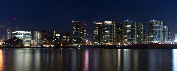 Obraz premium London, UK - Feb 7th, 2018: Inaugurated in Jan 2018, the new 518,000 sq foot, 12-story home of the United States Embassy in London at Nine Elms. Long-exposure night panorama overlooking River Thames, 