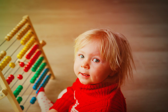little girl playing with abacus, learning math