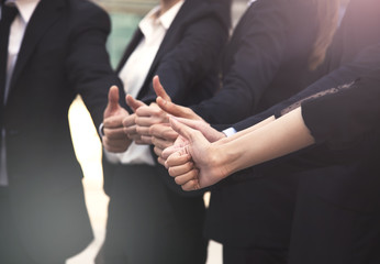 group businesspeople thumbs up together. concept teamwork and success.