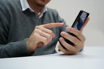 Male hand playing the smartphone Black