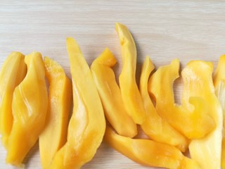 Fototapeta na wymiar Jackfruit cut into strips on wooden background, delicious slice fruit