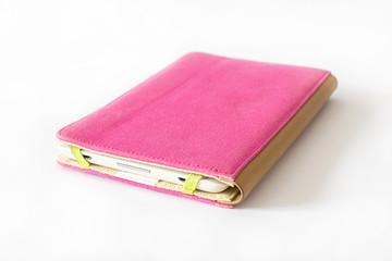 Close Up of an E-book reader in pink case on white background 