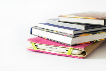 Close Up of an E-book reader in pink case covered with some old books